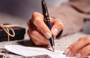 Woman_signing_a_cheque