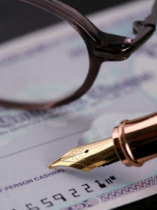 Signing_a_cheque-CMYK