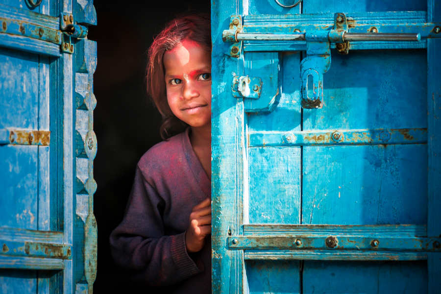 Little indian girl behind a door Investment